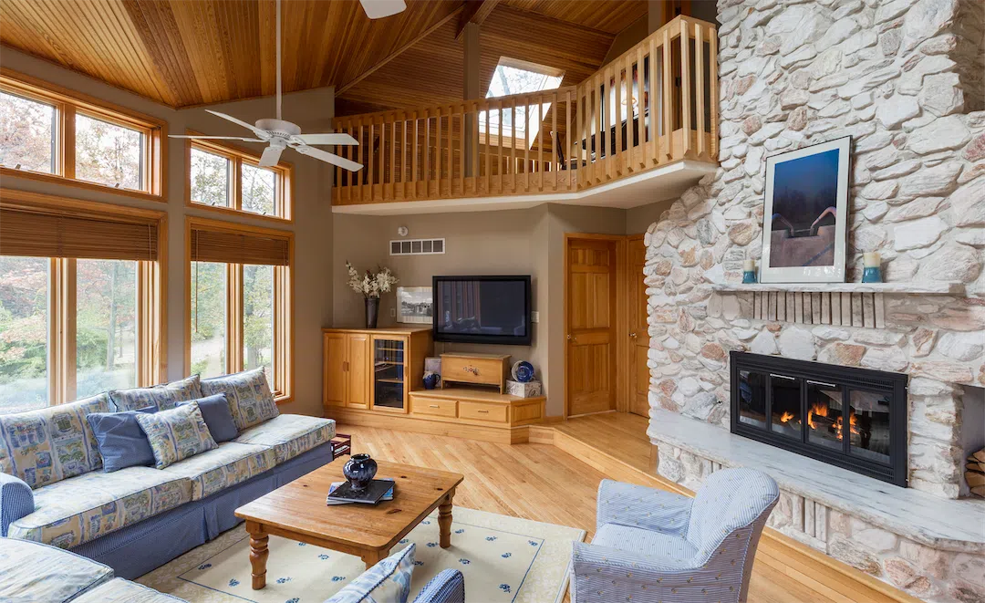 Cozy stone fireplace in a living room representing premium Chugiak rental interiors