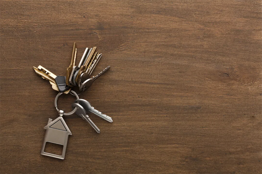 House-shaped keychain with keys representing Alaska rental property